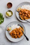 chicken curry plated with rice and garnishes