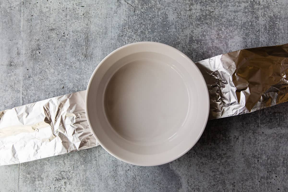 A foil sling under a casserole dish.