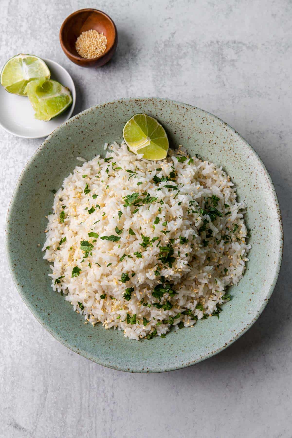 a bowl of coconut jasmine rice with lime wedge