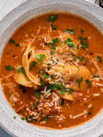 A bowl of tortellini soup.