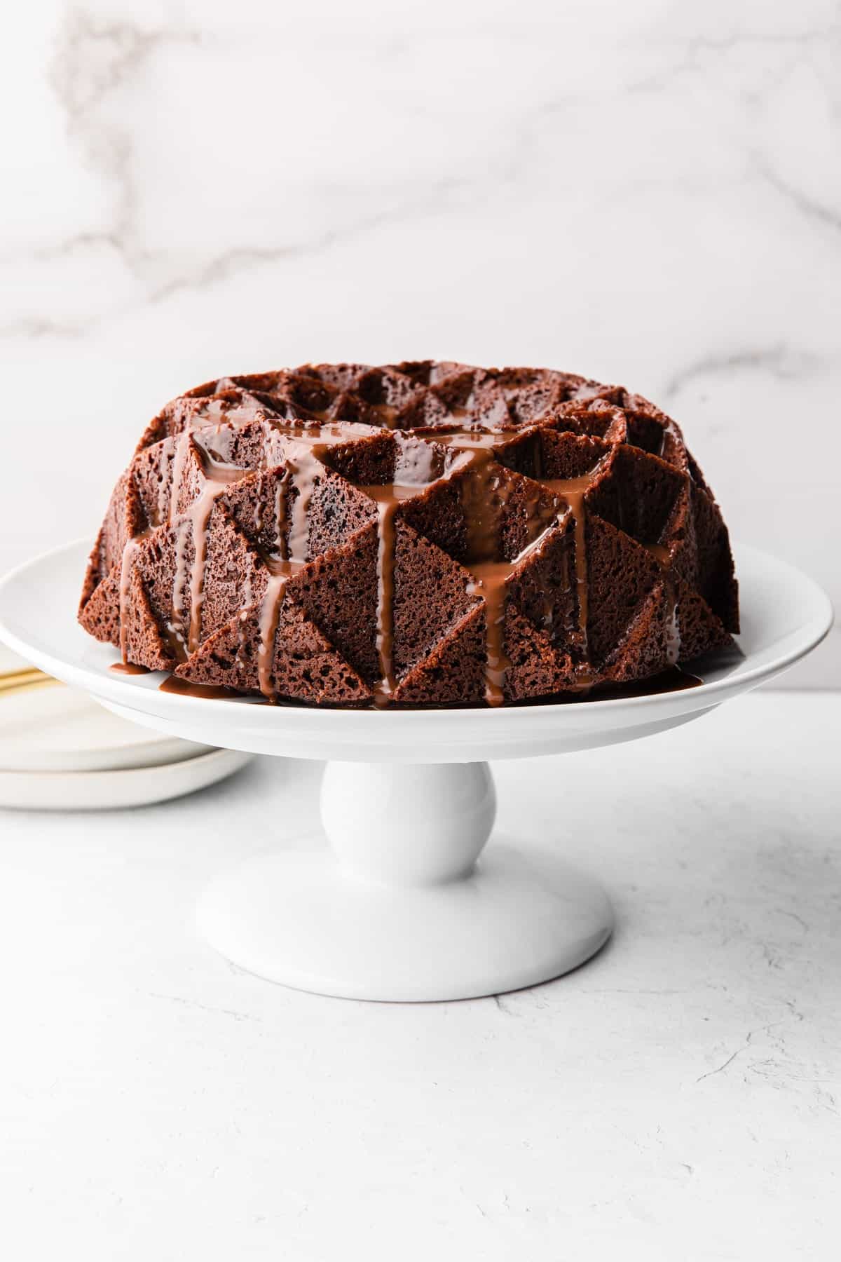 chocolate cake on a white cake stand