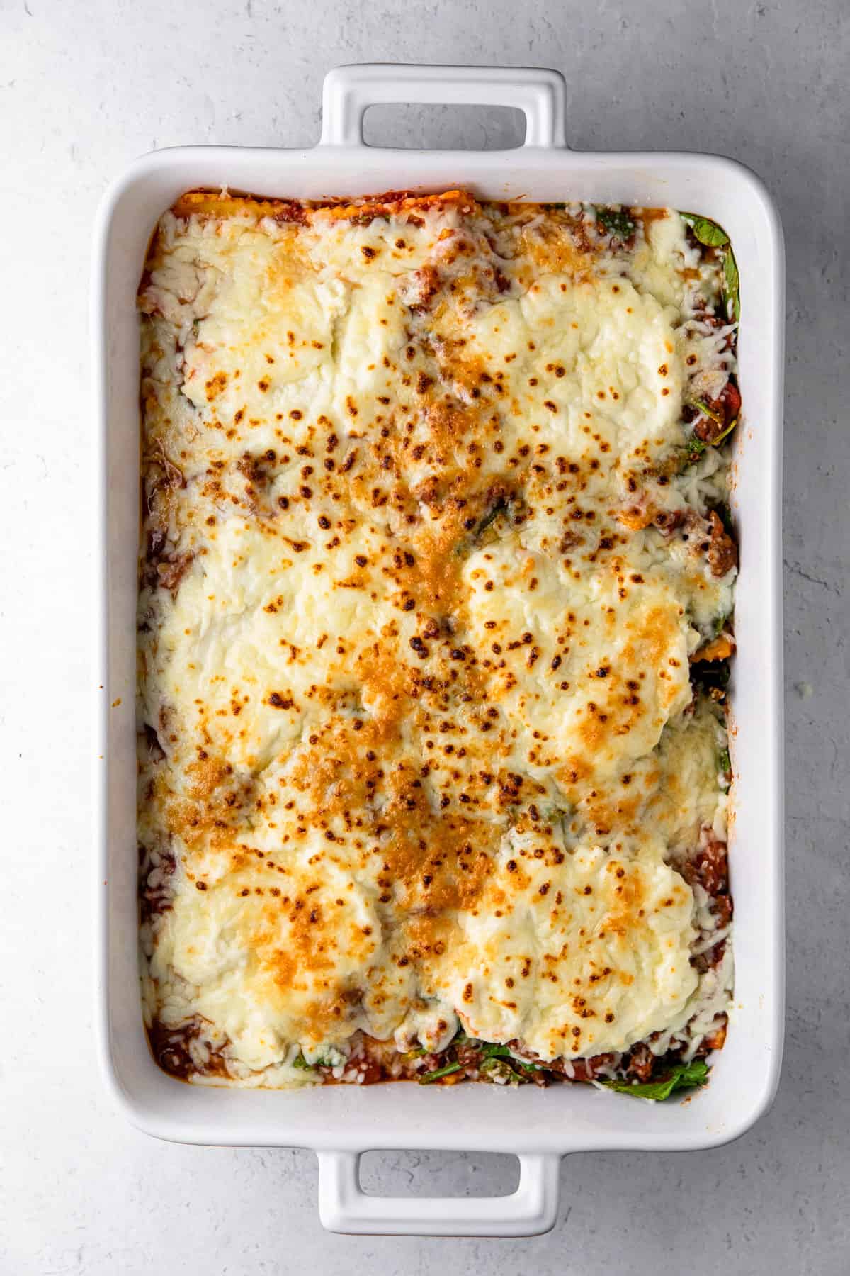 spinach ricotta ravioli in white casserole dish