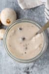 a jar of cream of mushroom soup substitute with a spoon in the jar