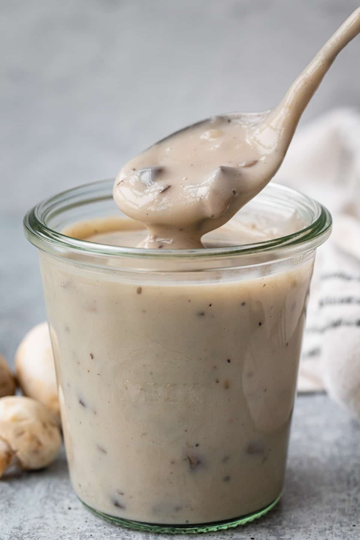 a spoon in a jar of cream of mushroom soup 