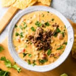 ground beef queso dip in a white bowl