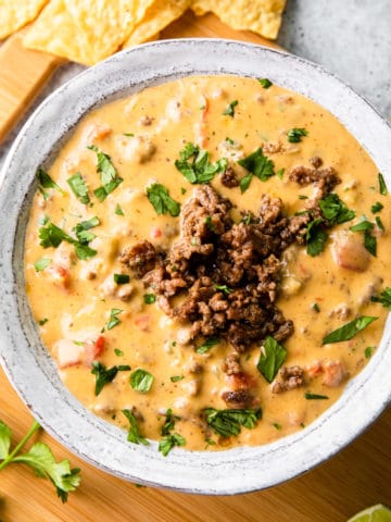 ground beef queso dip in a white bowl