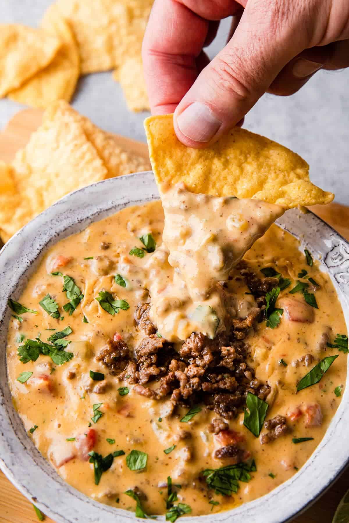 velveeta queso in a bowl with a chip dipping into it