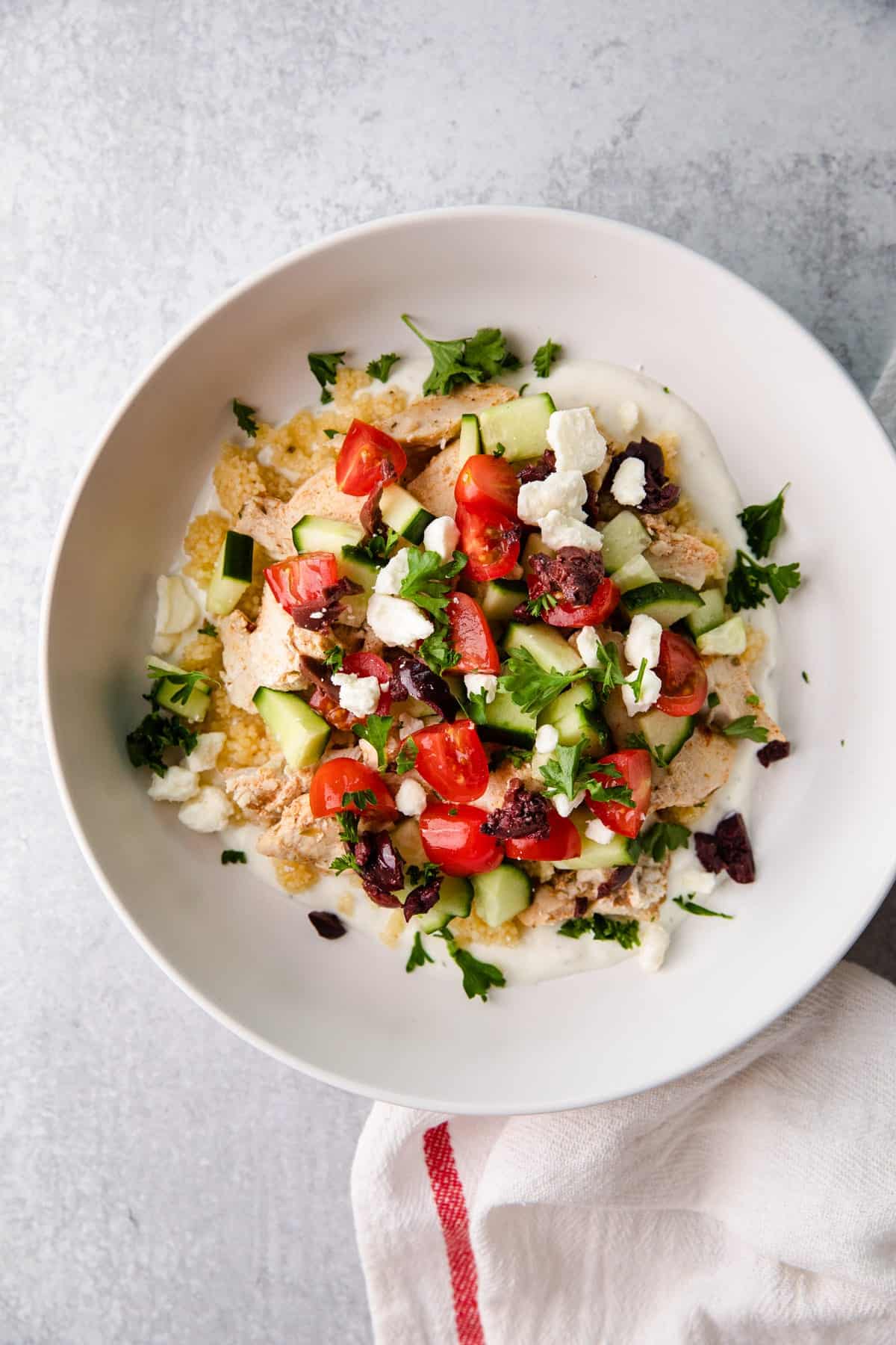 a bowl of greek chicken layered