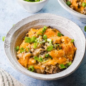 cheesy rice and ground beef casserole scooped into a white bowl