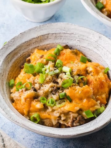 cheesy rice and ground beef casserole scooped into a white bowl