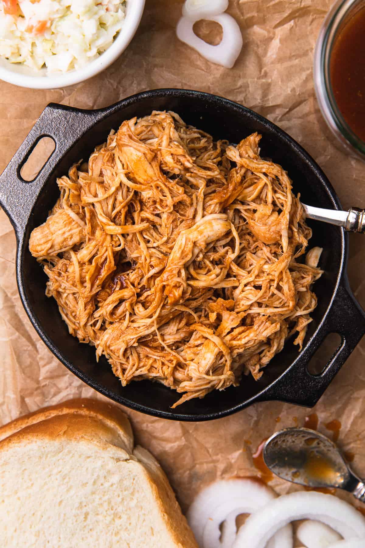 Shredded bbq chicken surrounded by fixins 