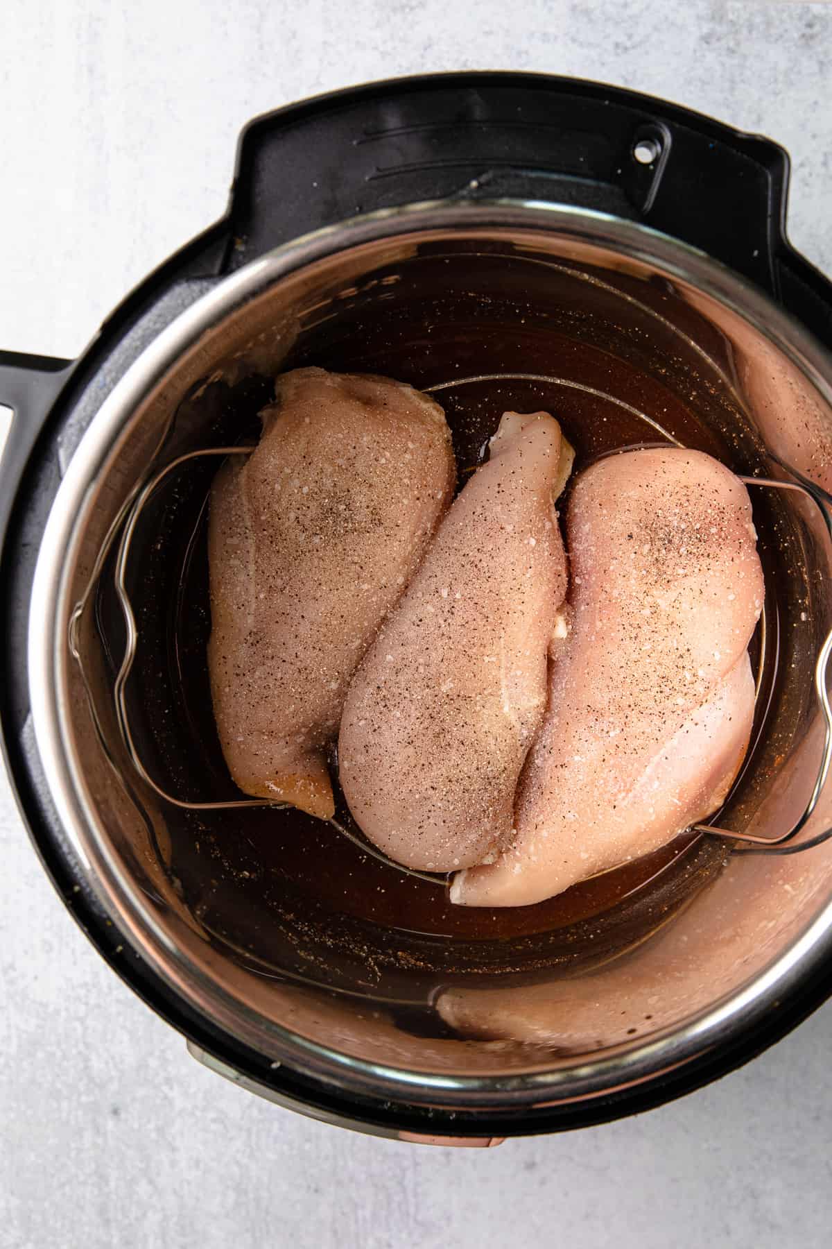 sauce and raw chicken in instant pot