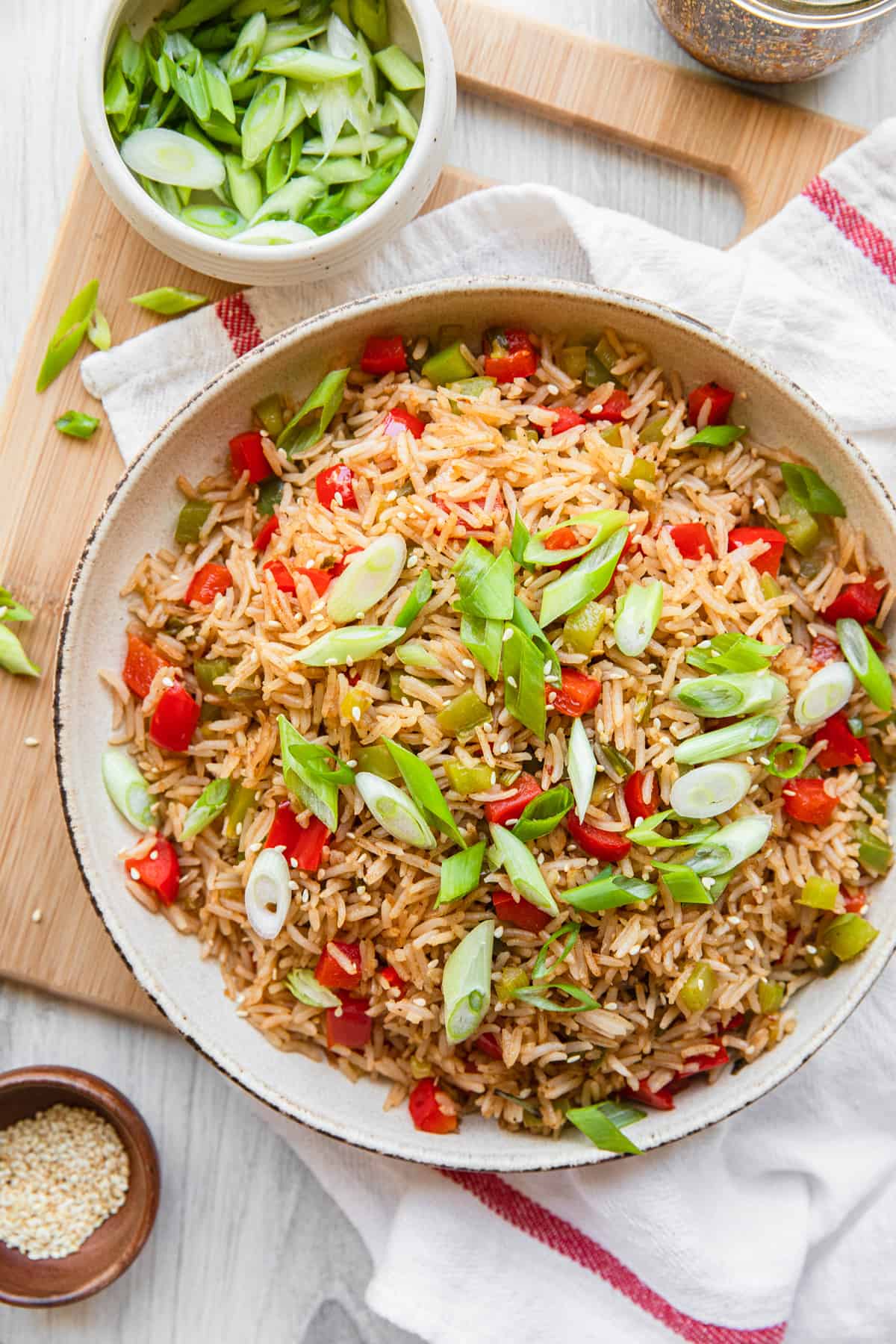 a bowl of fried rice and green onions