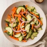 a bowl of a carrot and cucumber salad