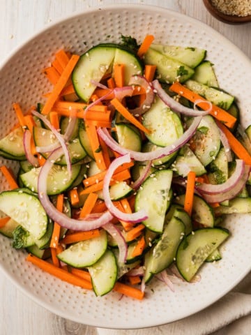 a bowl of a carrot and cucumber salad