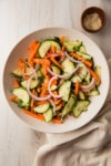 a bowl of carrot cucumber salad