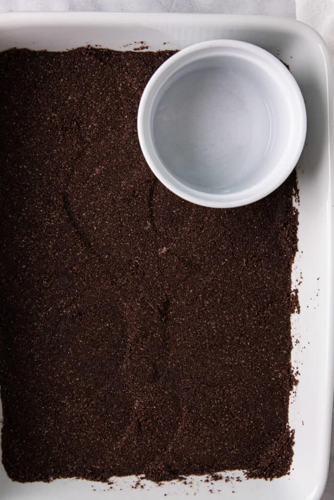 Pressing crumbs into baking dish.