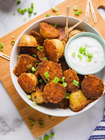 cooked potatoes in a bowl with dipping sauce