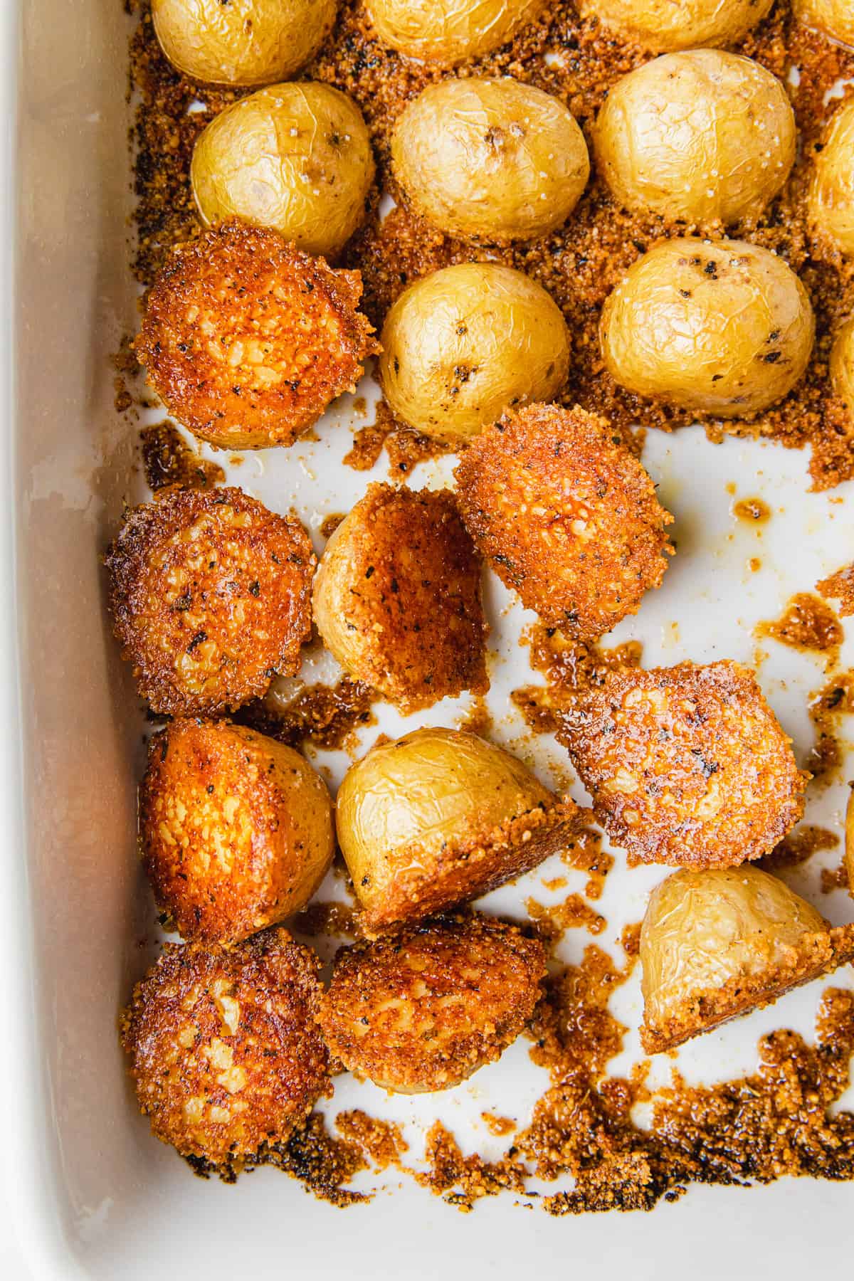 Cooked potatoes flipped over in a baking dish.