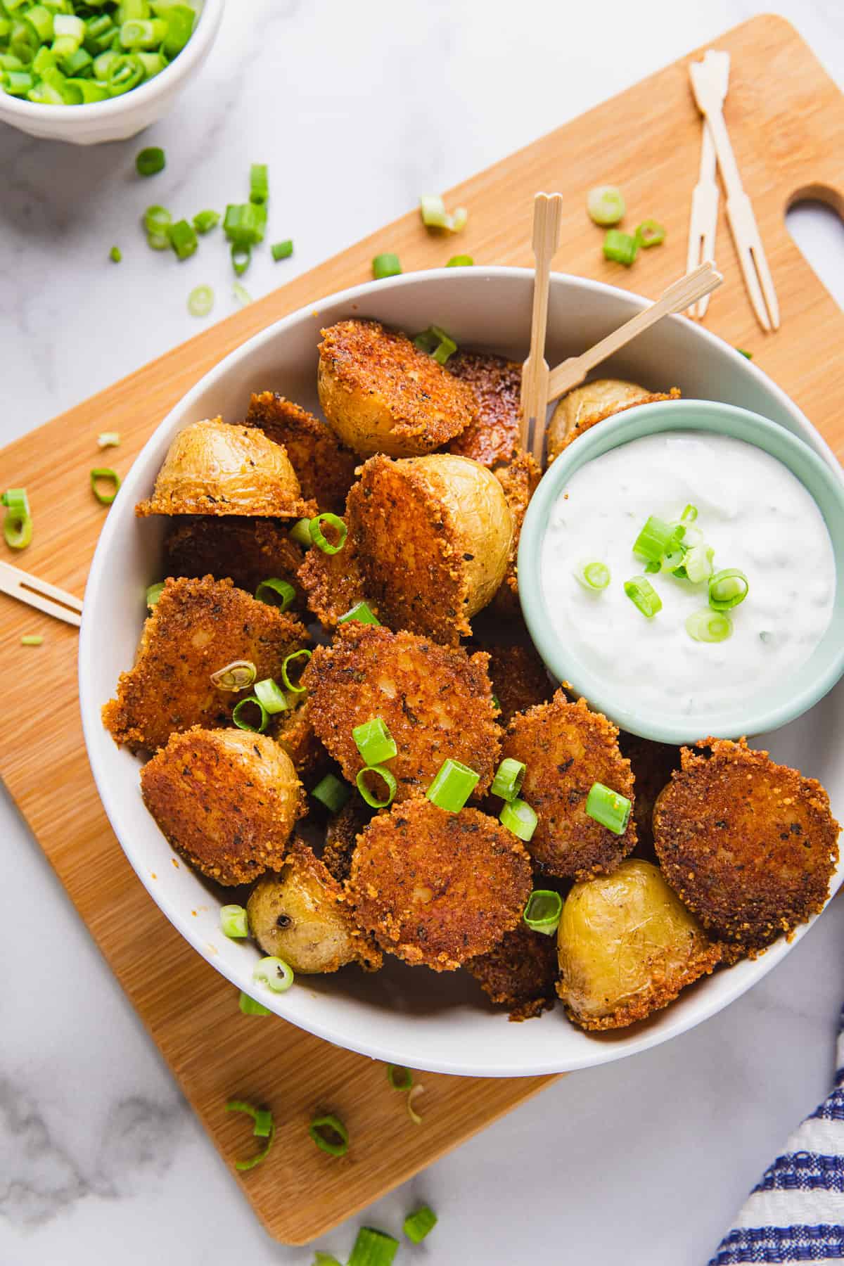 cooked potatoes in a bowl with dipping sauce