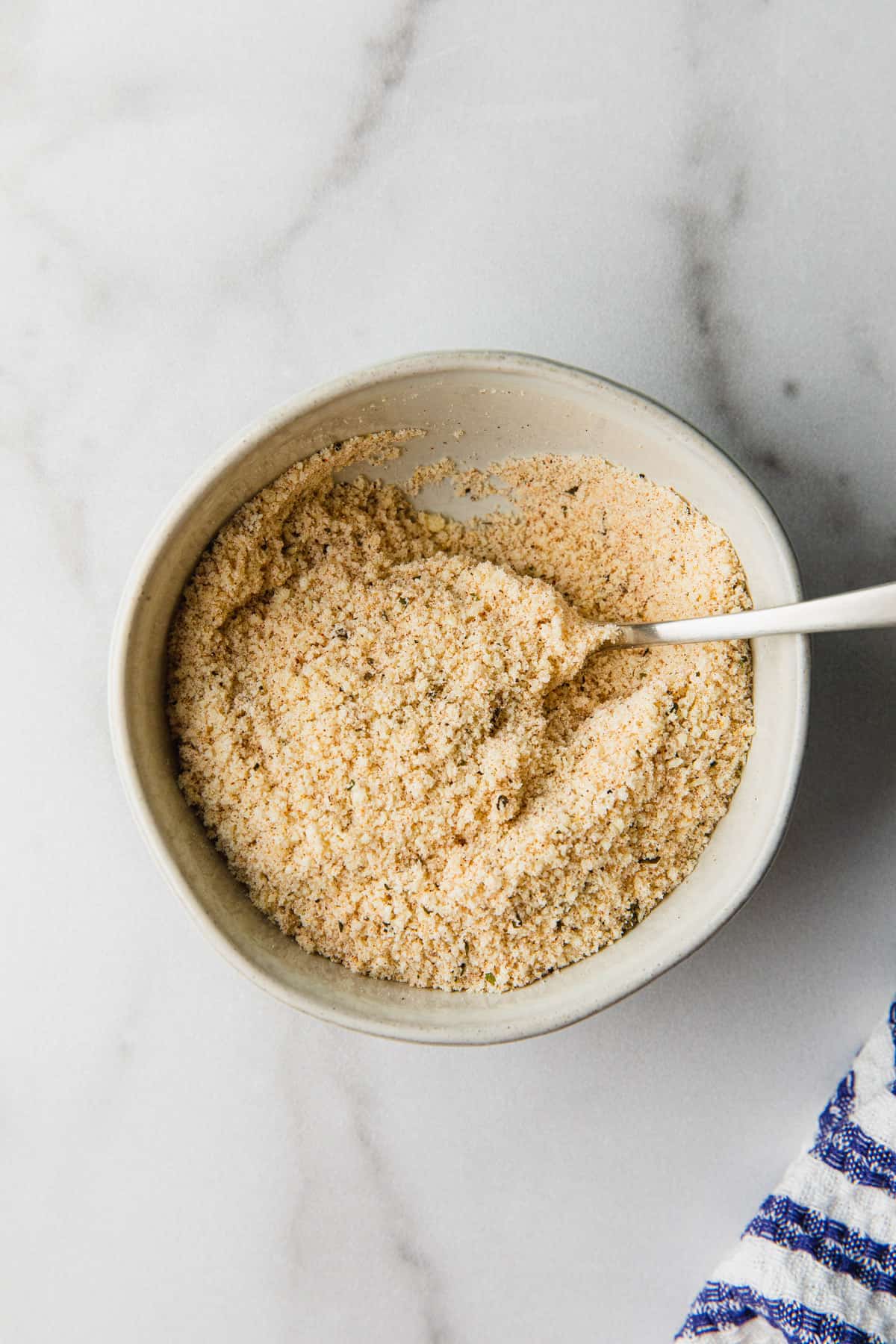 mixing parmesan cheese and herbs and spices