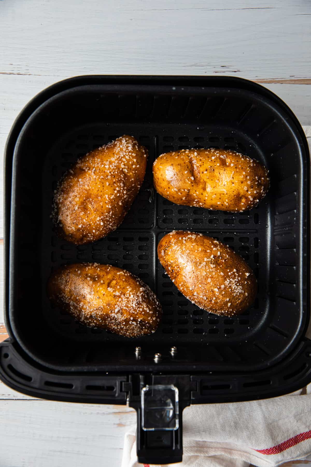 4 potatoes in an air fryer basket