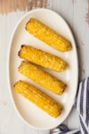 a platter with corn on the cob