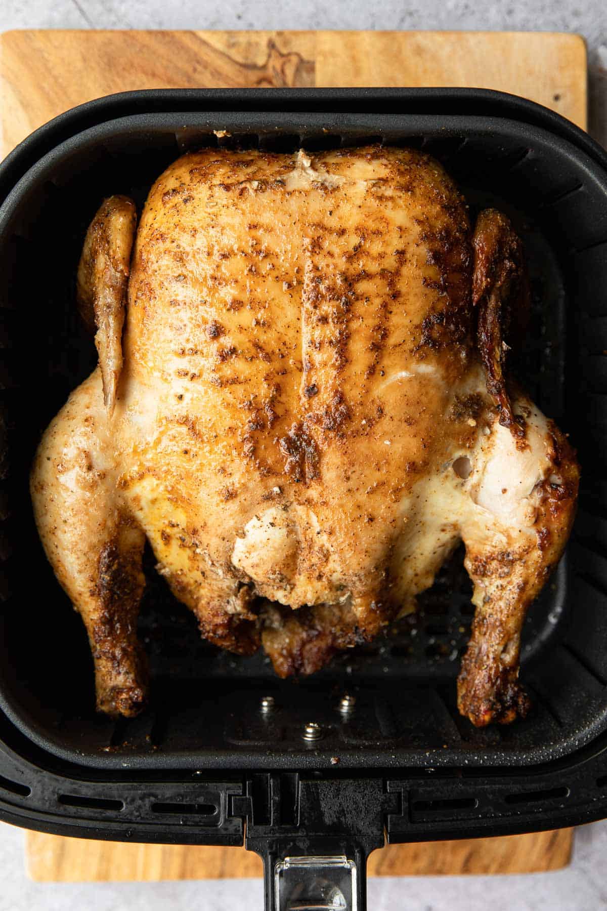 breast up chicken being cooked