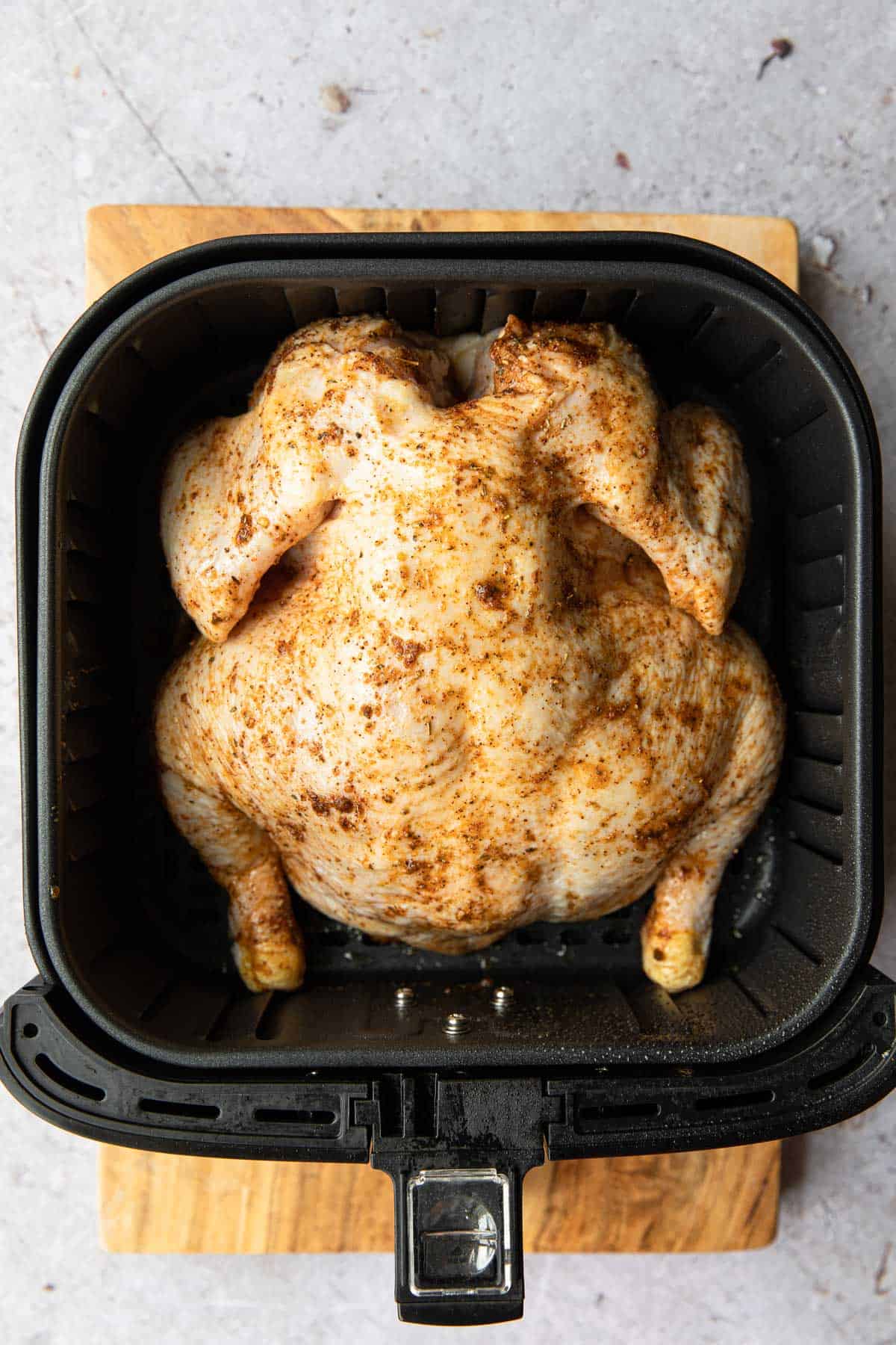 chicken breast down in an air fry basket