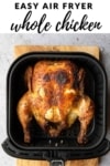 a whole cooked chicken in an air fryer basket