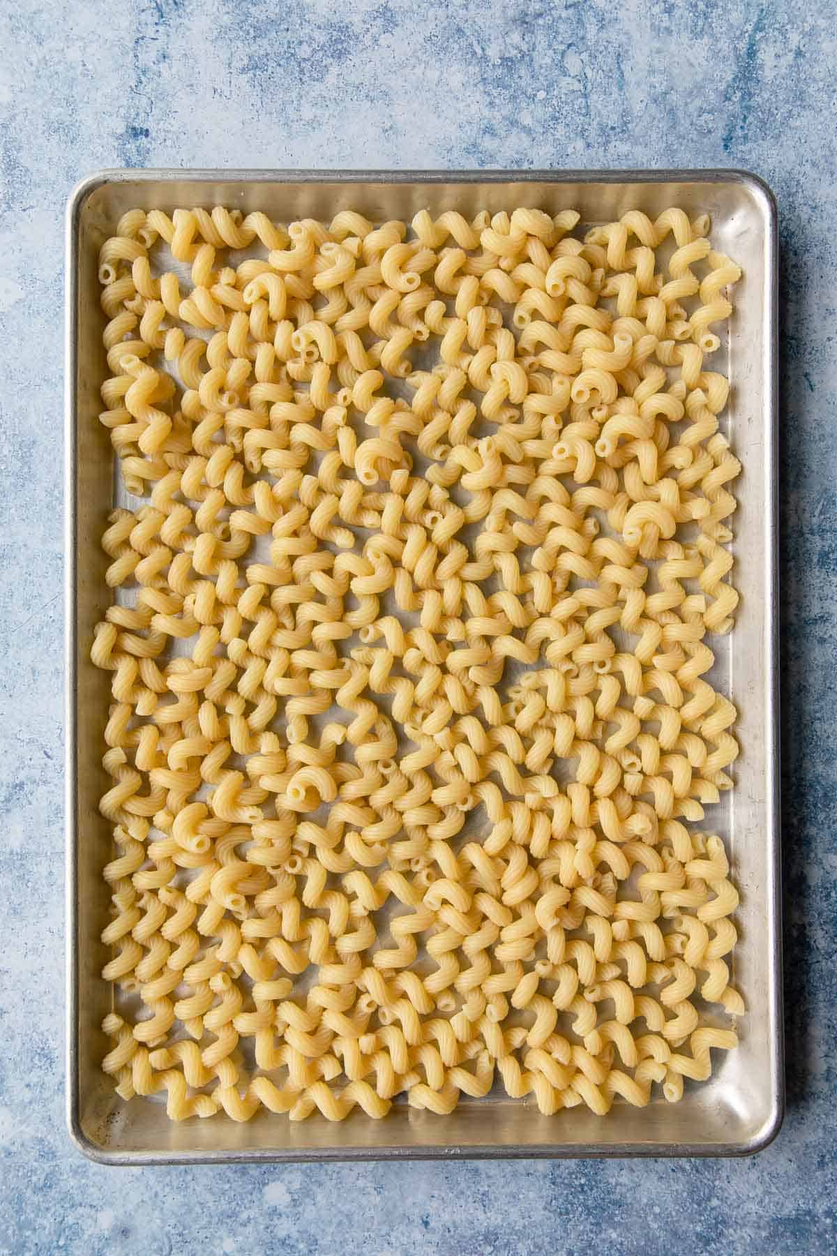 a  sheet pan with pasta drying