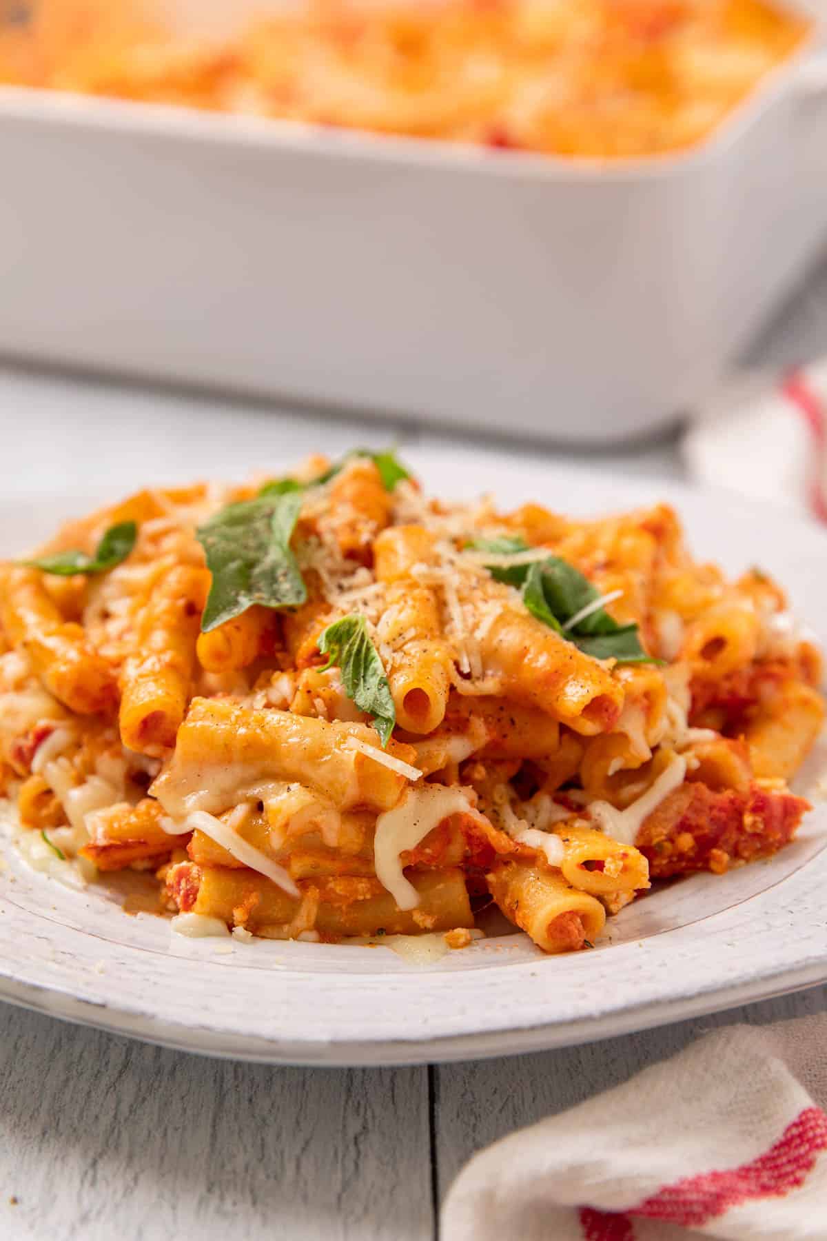 a plate of baked pasta with red sauce