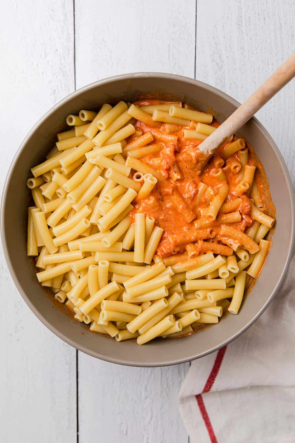 a bowl of sauce and ziti before mixing