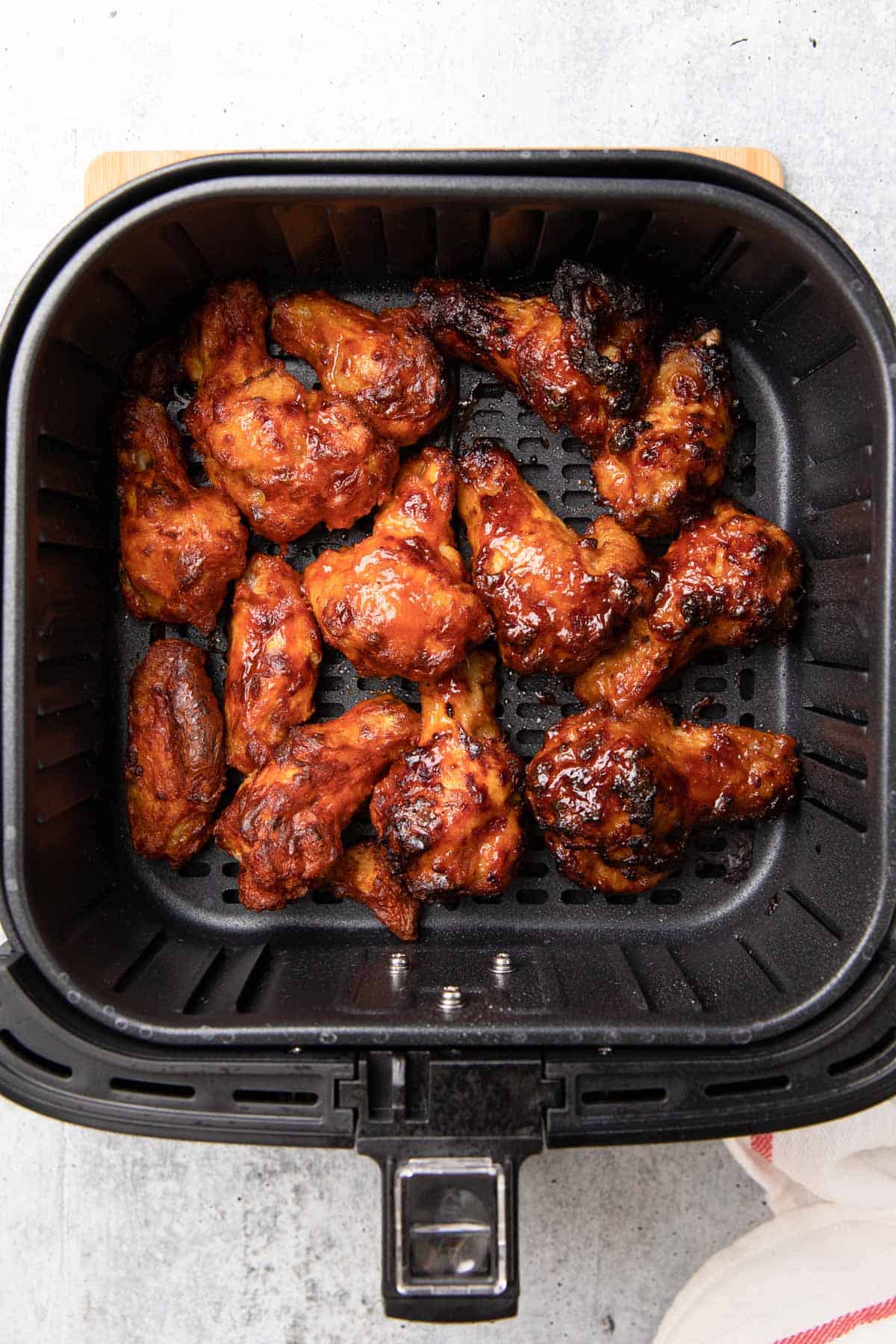 cooked wings in fryer basket