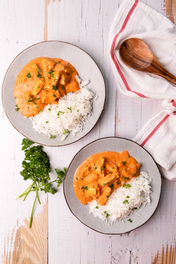 two plates of brazilian chicken stroganoff on a white background