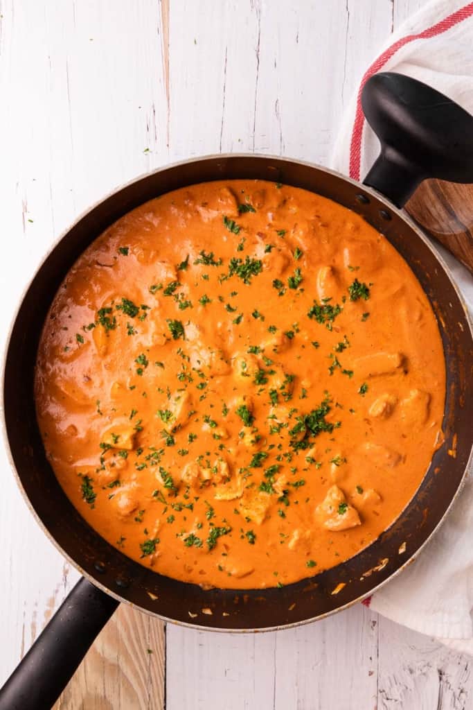 creamy tomato sauce with chicken in a skillet
