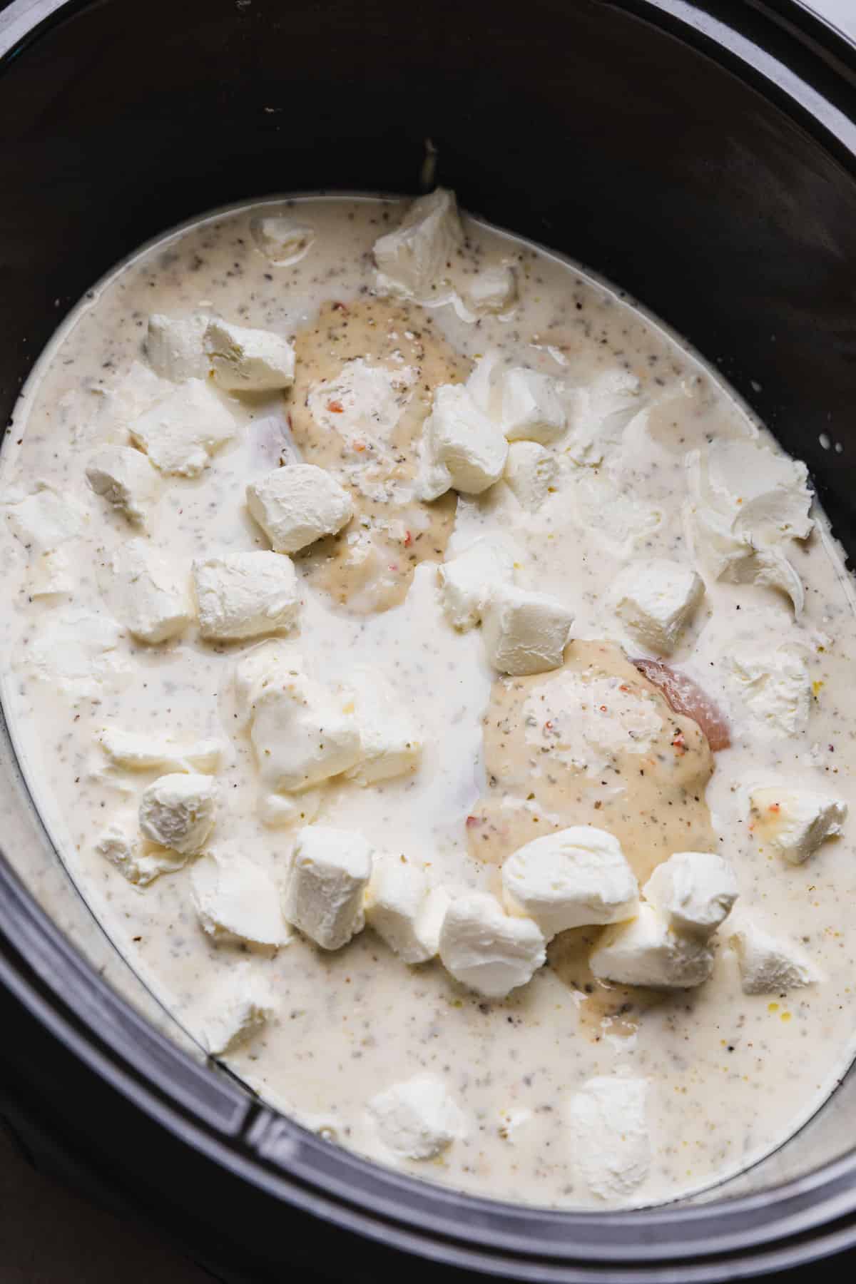 cubed cream cheese added to crockpot