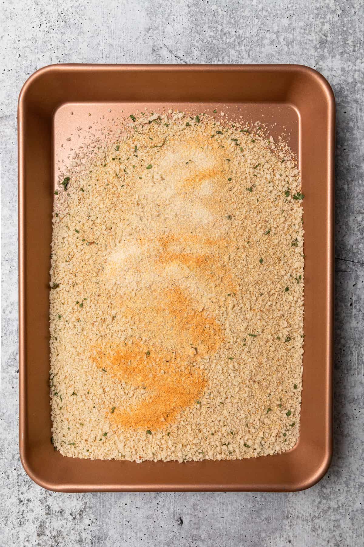 a sheet pan with seasoned breadcrumbs