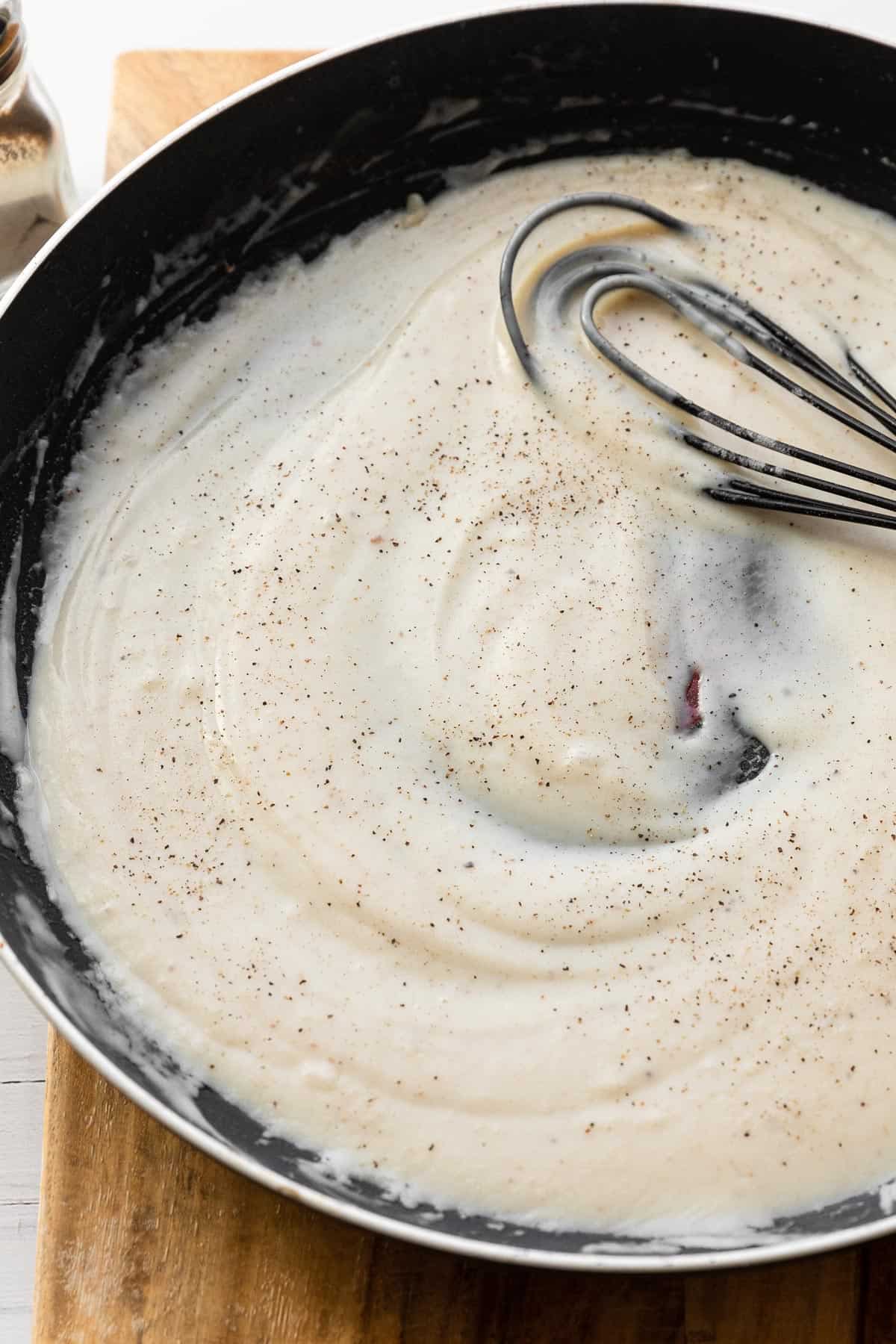 a skillet with white cream gravy