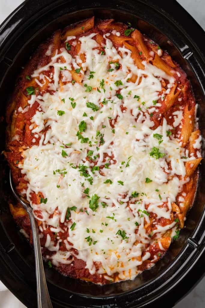 shredded cheese melted over the top of a crockpot baked ziti