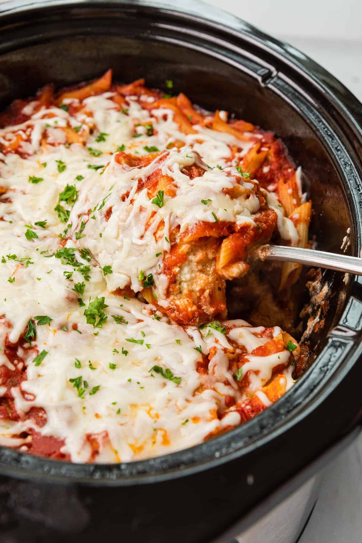  a crockpot filled with baked ziti