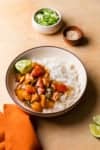 a saucy chicken dish in a bowl with rice