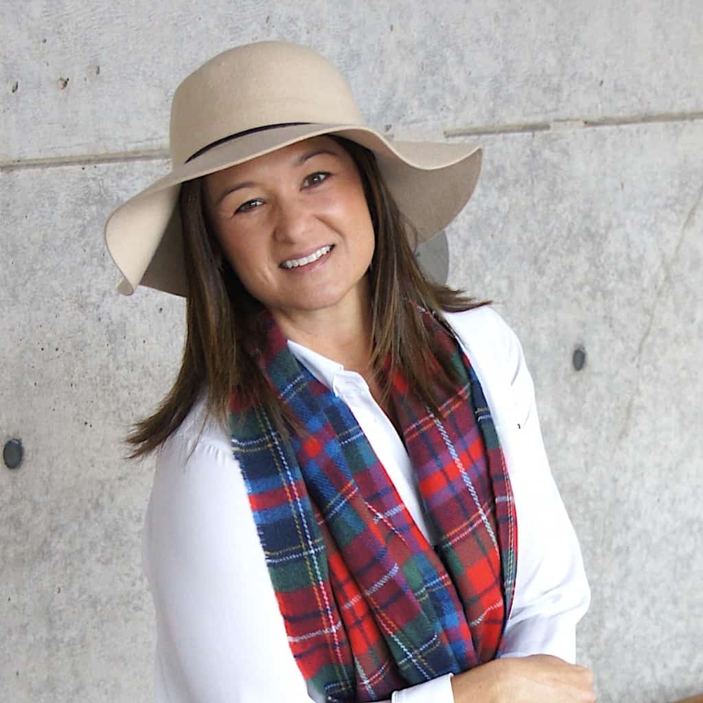 a young lady with a hat on smiling