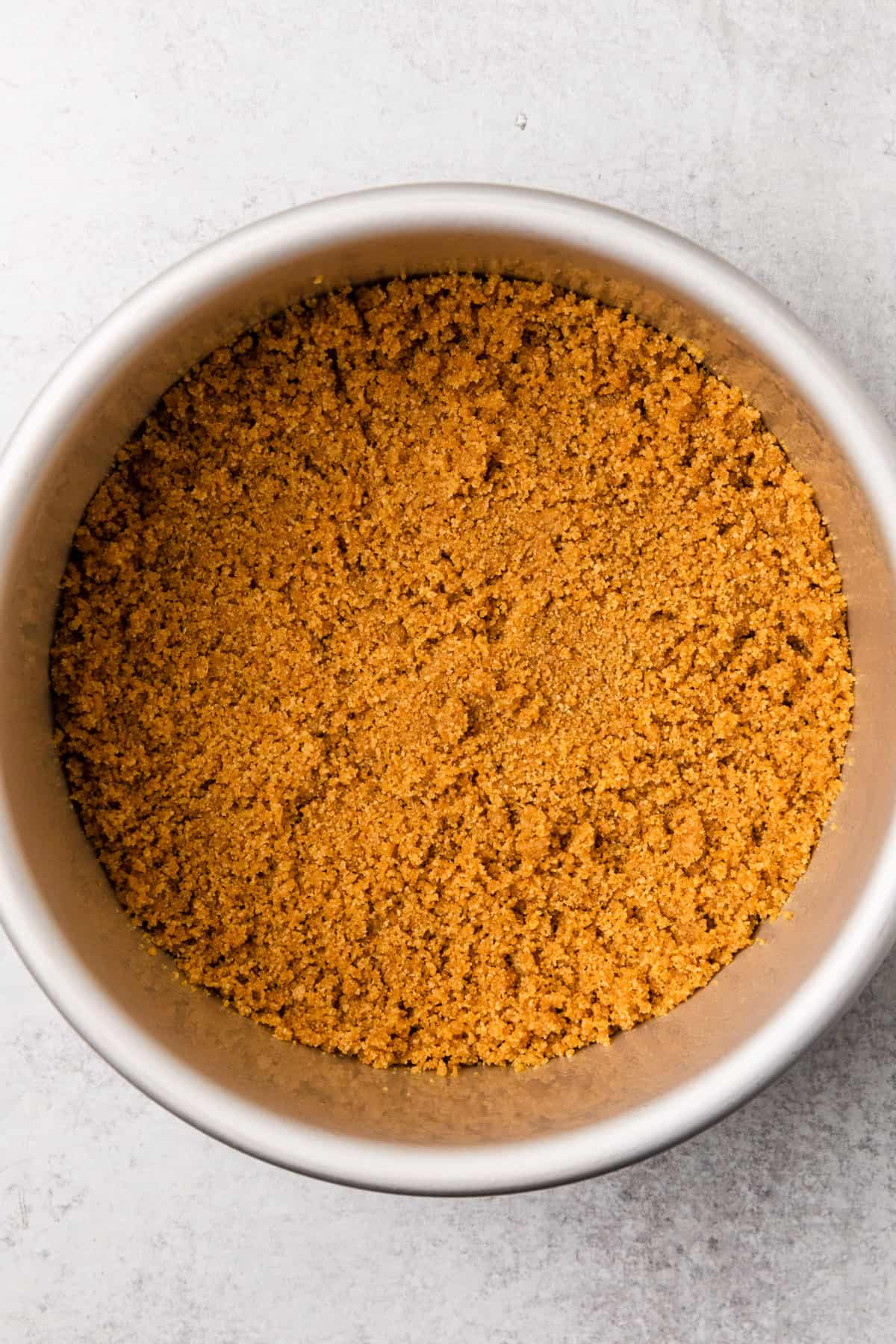 graham cracker crumbs in a springform pan