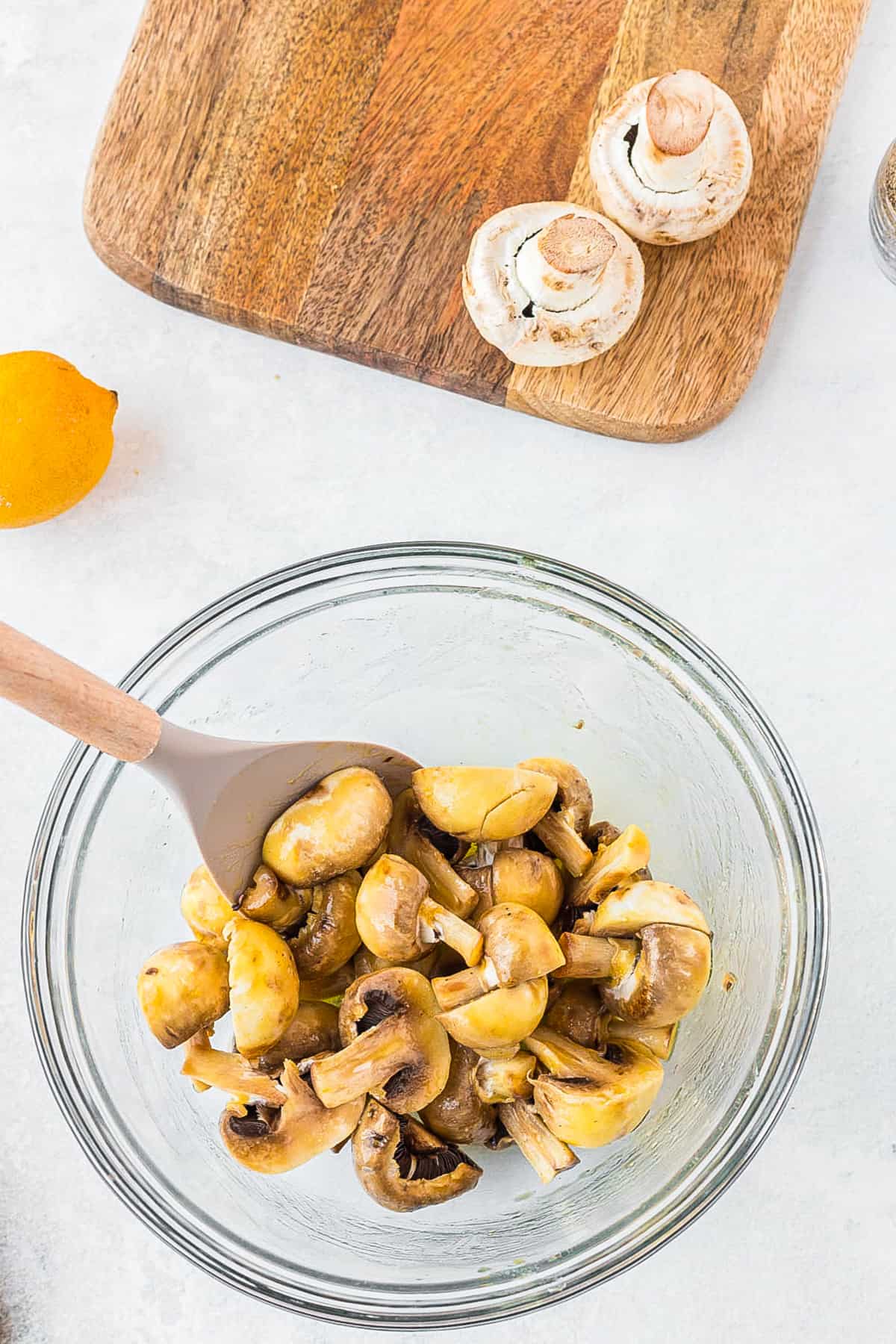 mushrooms being stirred into olive oil 