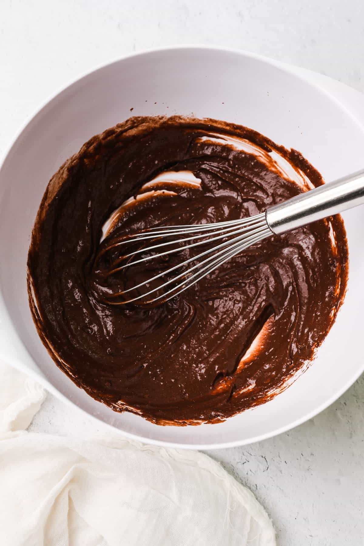 using a whisk to mix a chocolate pudding