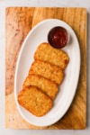 a platter of cooked hash brown patties