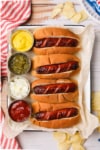 prepared hot dogs with condiments on the side