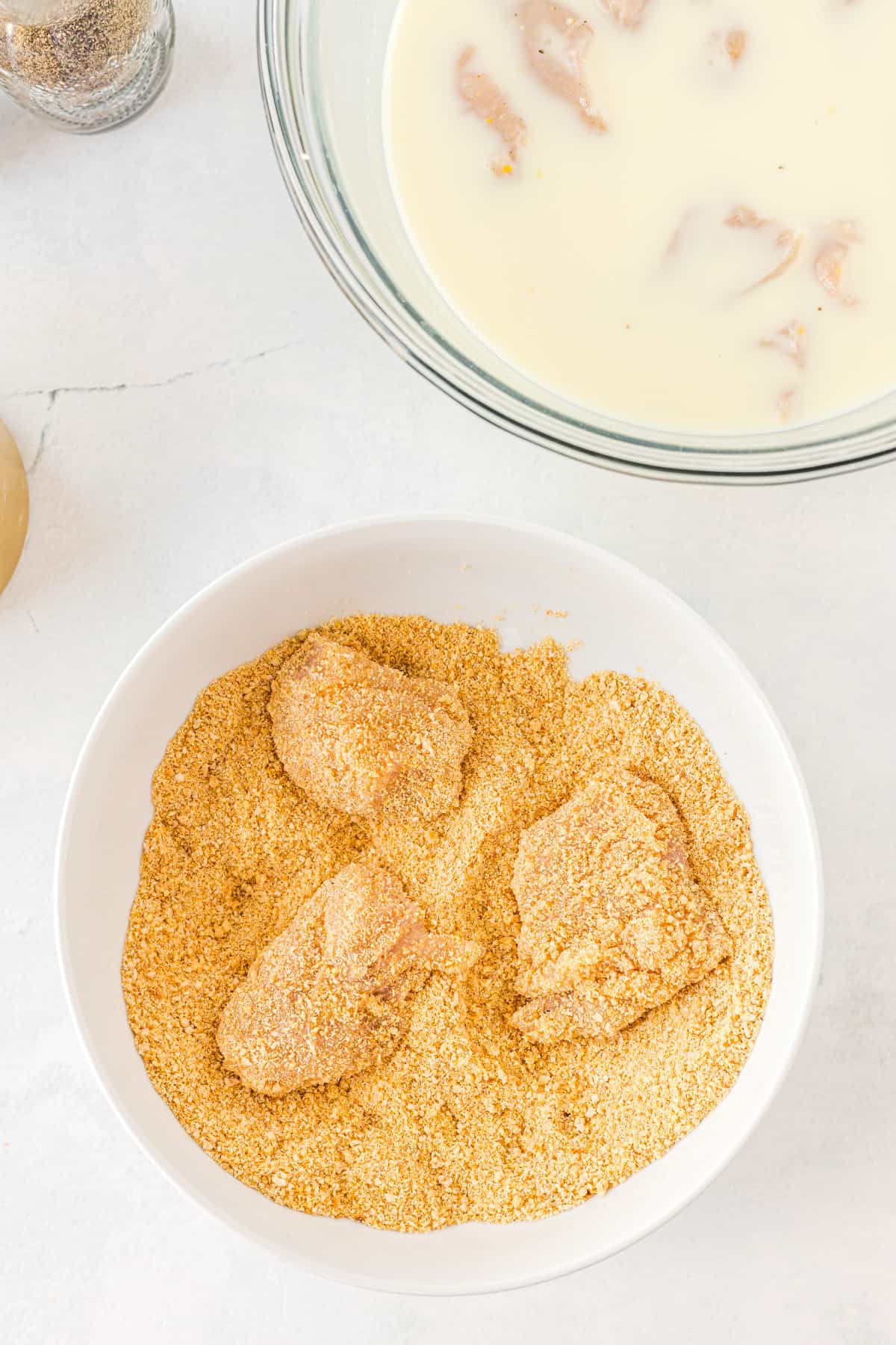 coating chicken in breadcrumbs