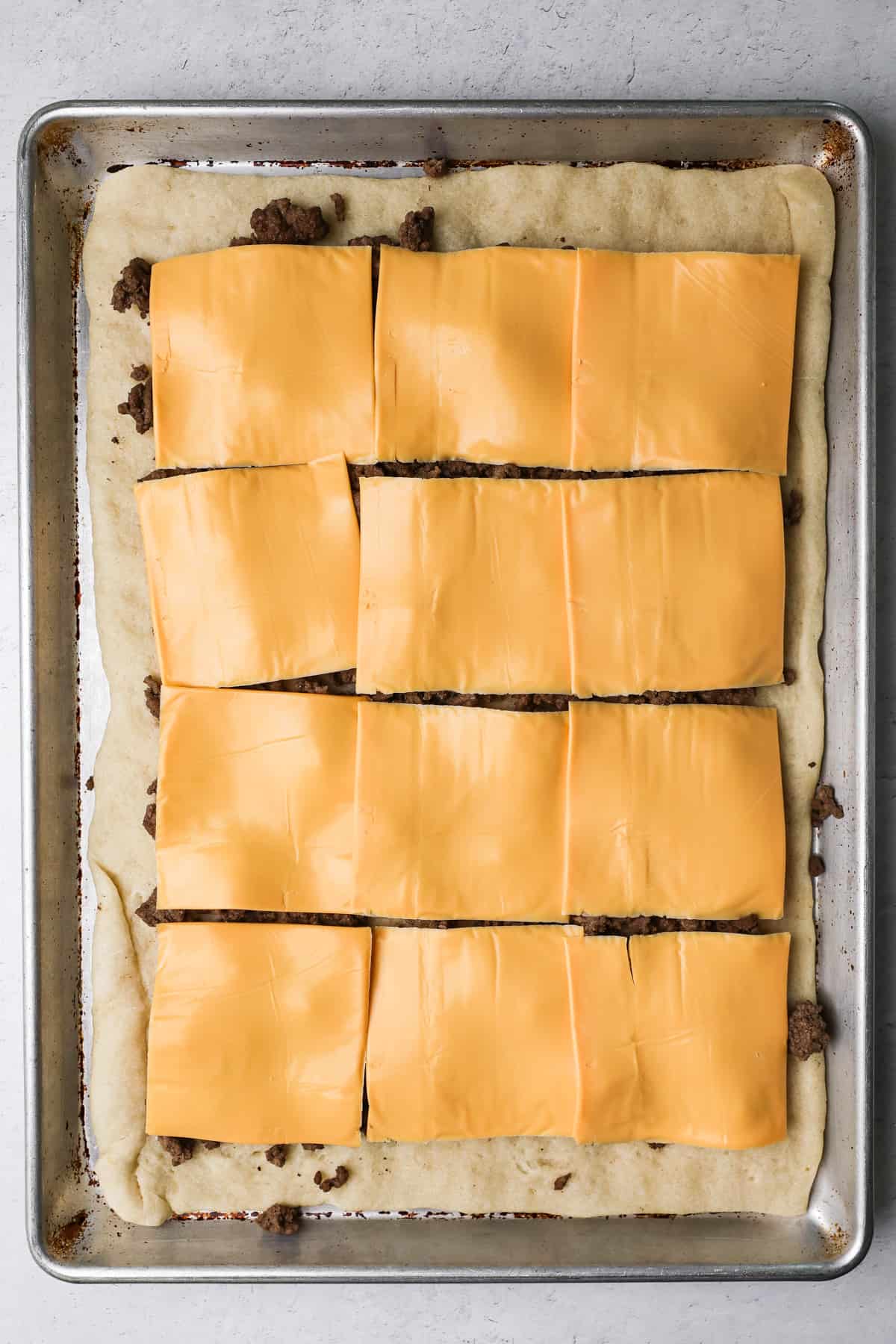 American cheese layered on pizza.
